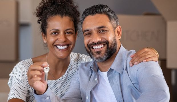 Couple Holding Keys to New Home