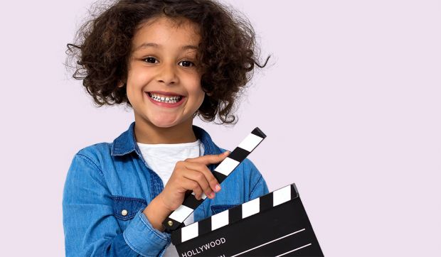 Child holding a clapboard
