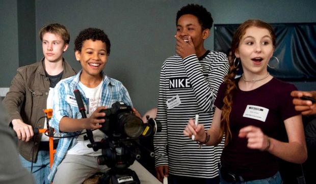 A group of children operating film equipment.