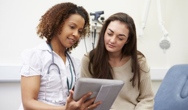 A doctor reviewing a chart with a patient.