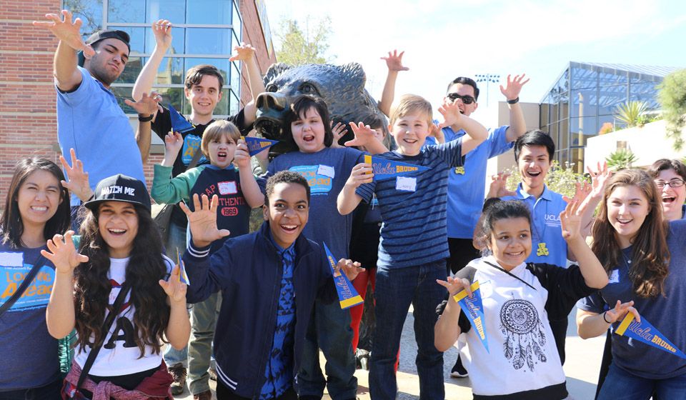 A group of kids of various ages pose in front of the camera