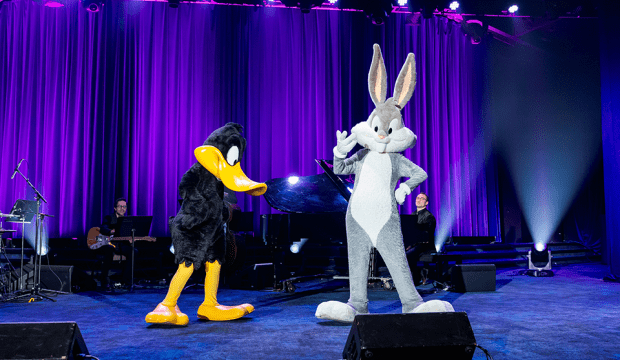 Costume characters Bugs Bunny and Daffy Duck on a stage