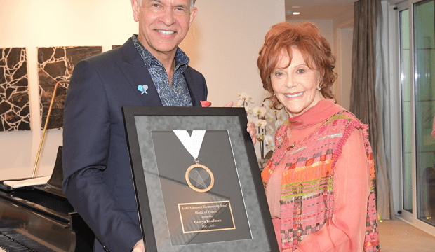 Brian Stokes Mitchell and Glorya Kaufman holding the Medal of Honor