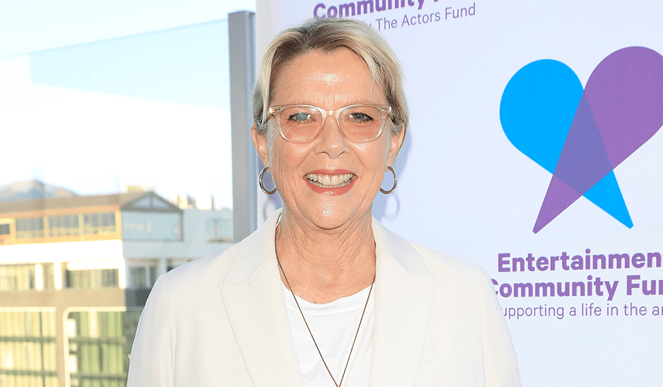 Annette Bening stands in front of an Entertainment Community Fund step-and-repeat